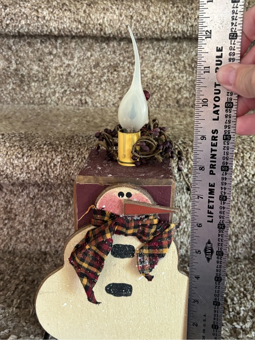 Wooden snowman with electric candle
